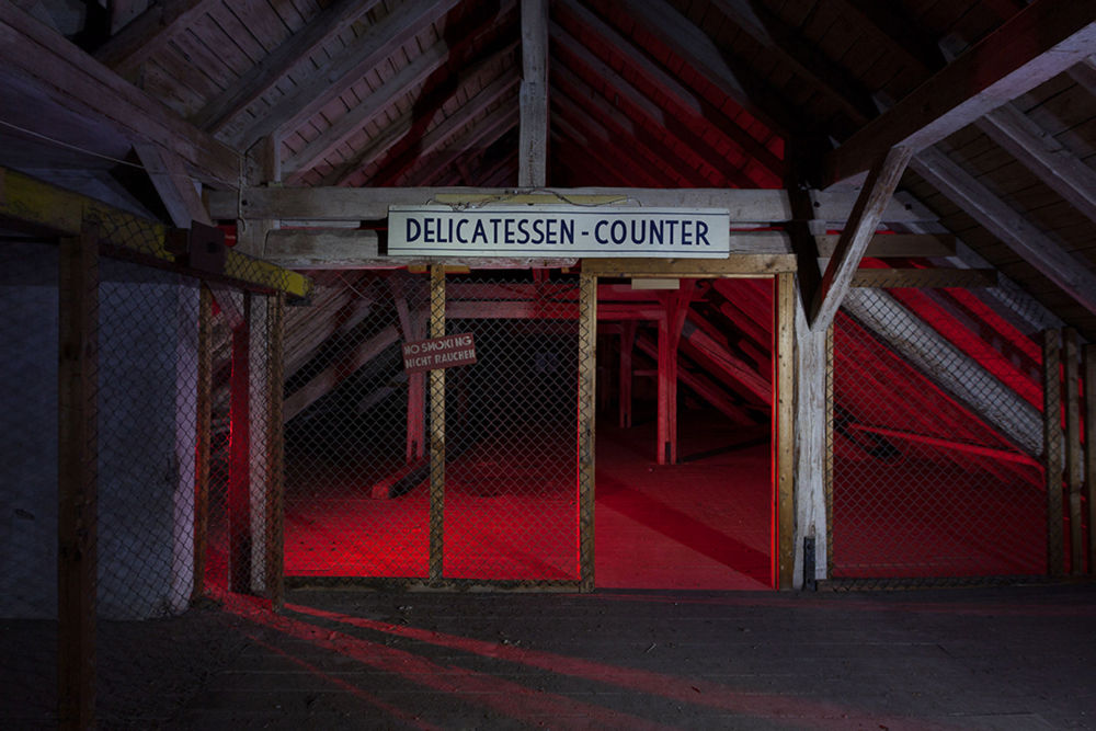 abandoned delicatessen counter in attic with red light