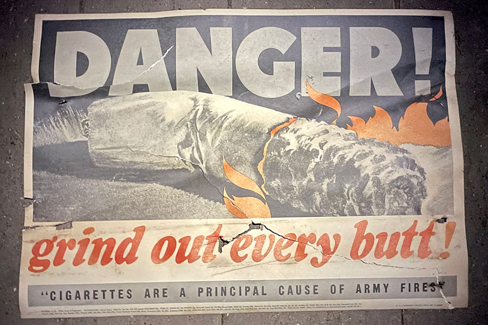 vintage military fire warning poster on attic floor